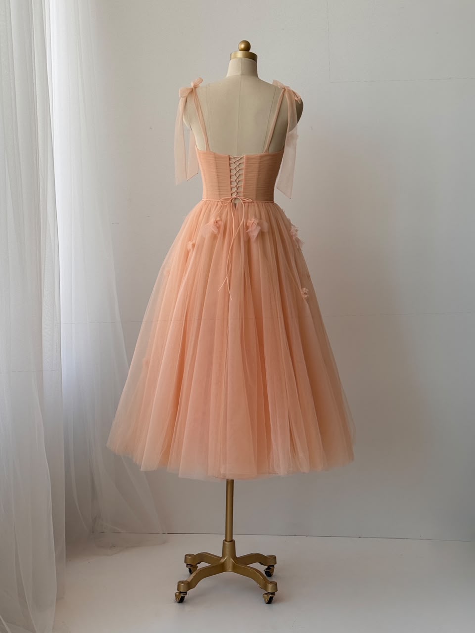 Peach midi dress with bow straps and embroidered flowers