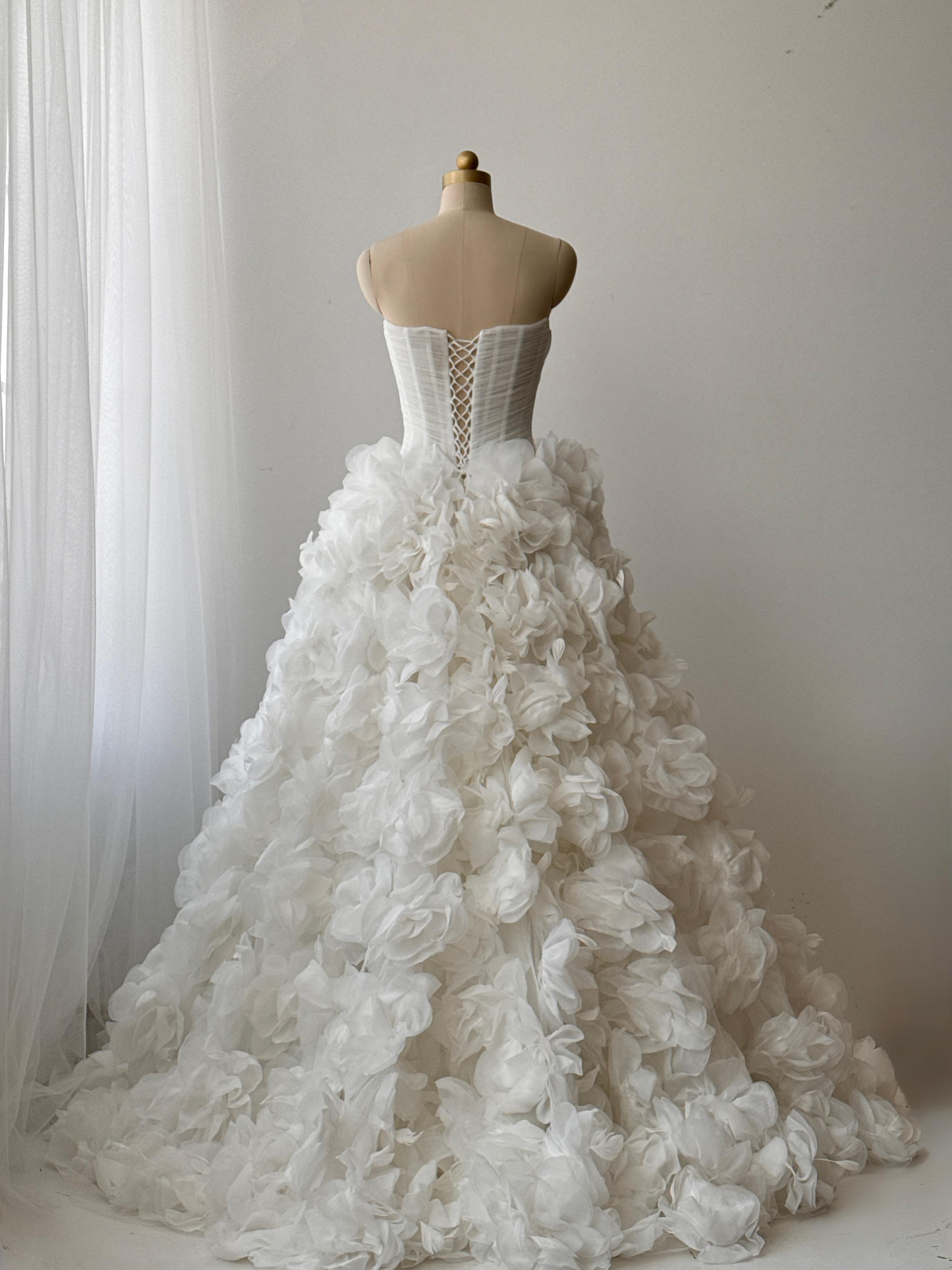 White bridal A-line gown with ruffles and no sleeves