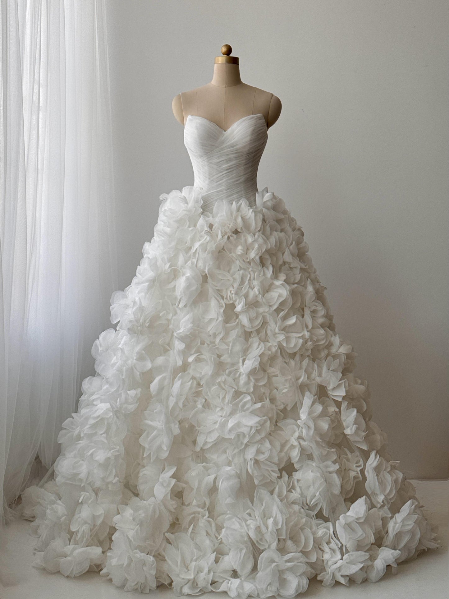 White bridal A-line gown with ruffles and no sleeves