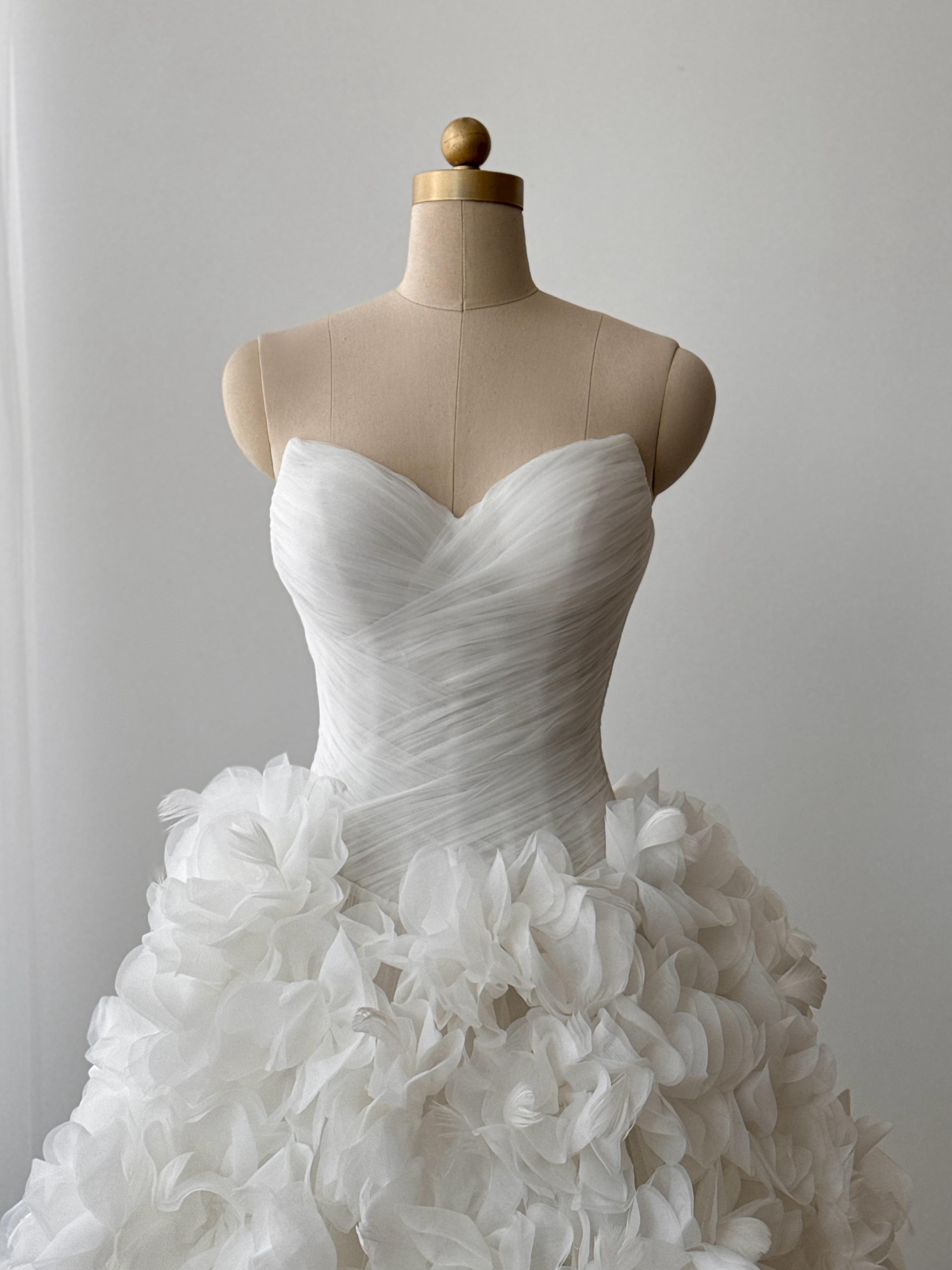 White bridal A-line gown with ruffles and no sleeves
