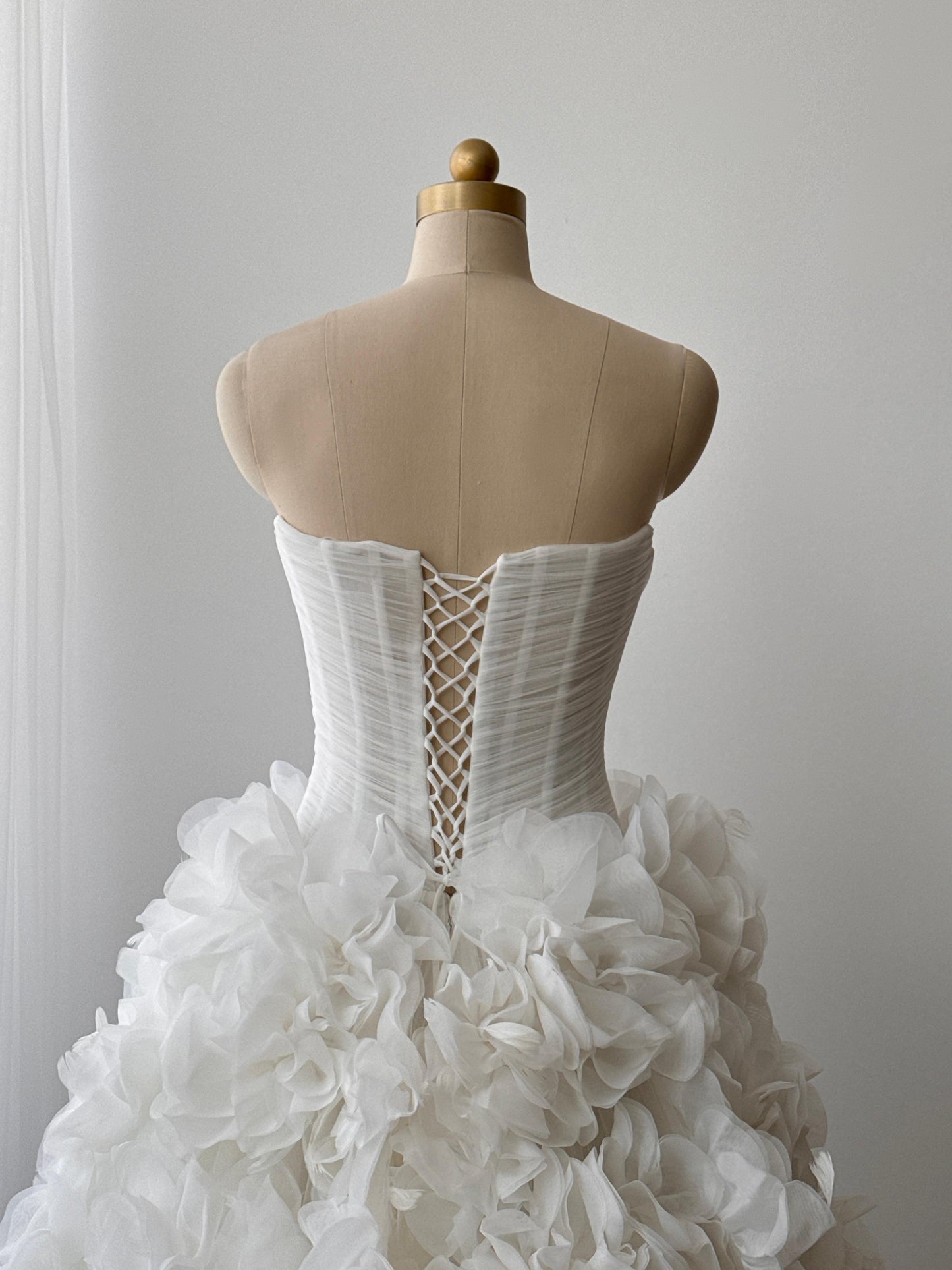 White bridal A-line gown with ruffles and no sleeves