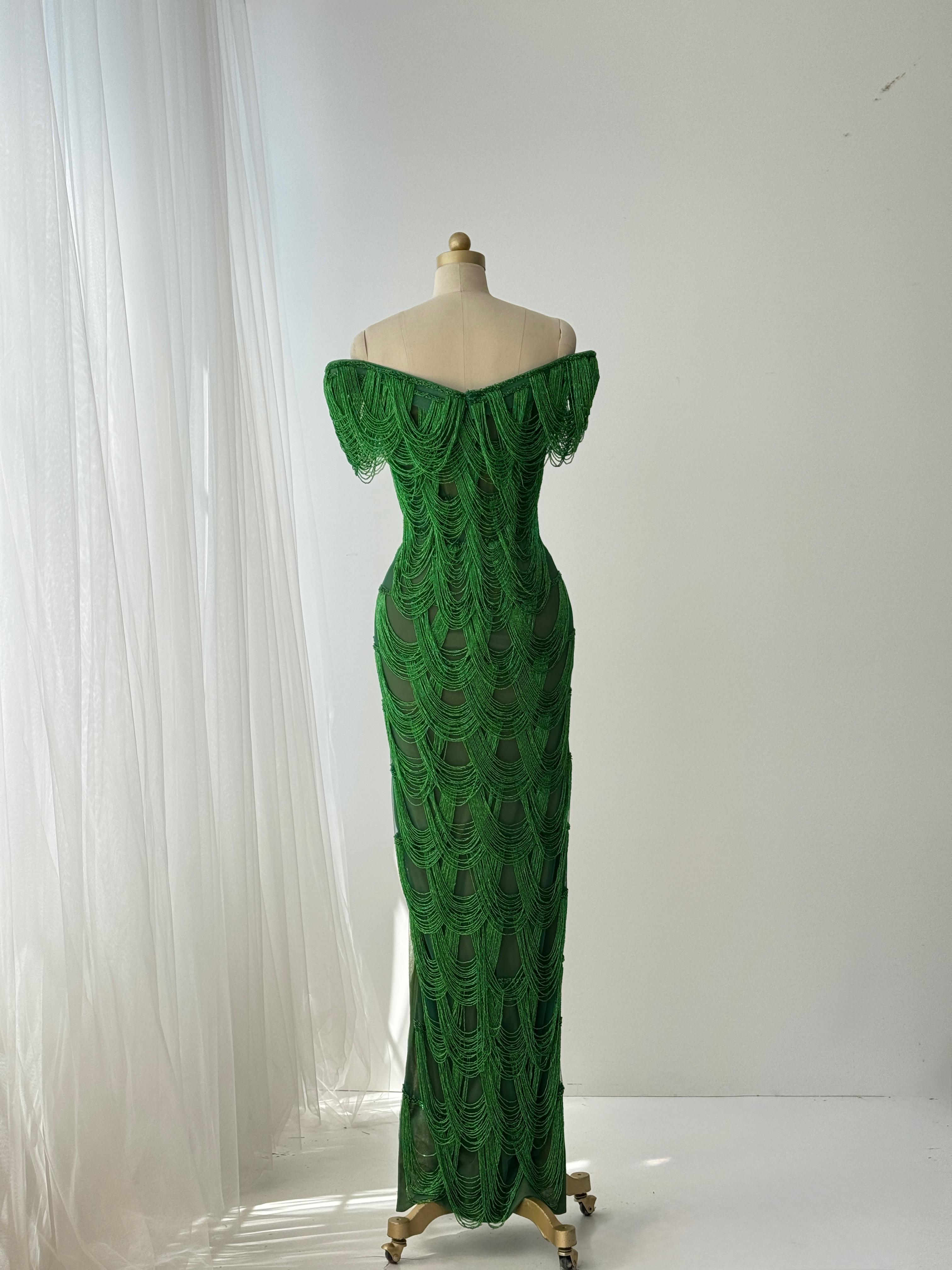 Dark green mermaid gown with off the shoulder straps and fringes