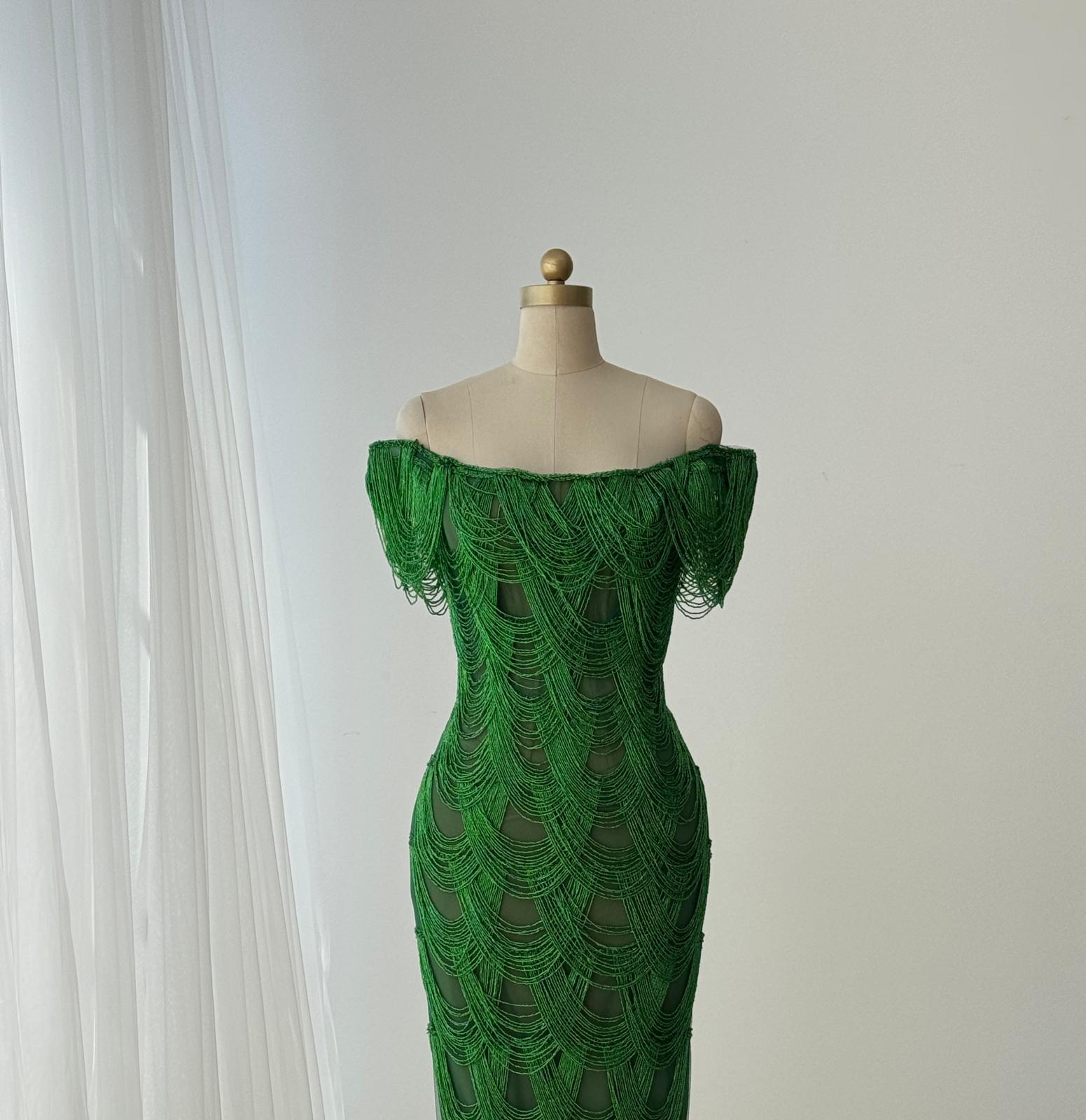 Dark green mermaid gown with off the shoulder straps and fringes