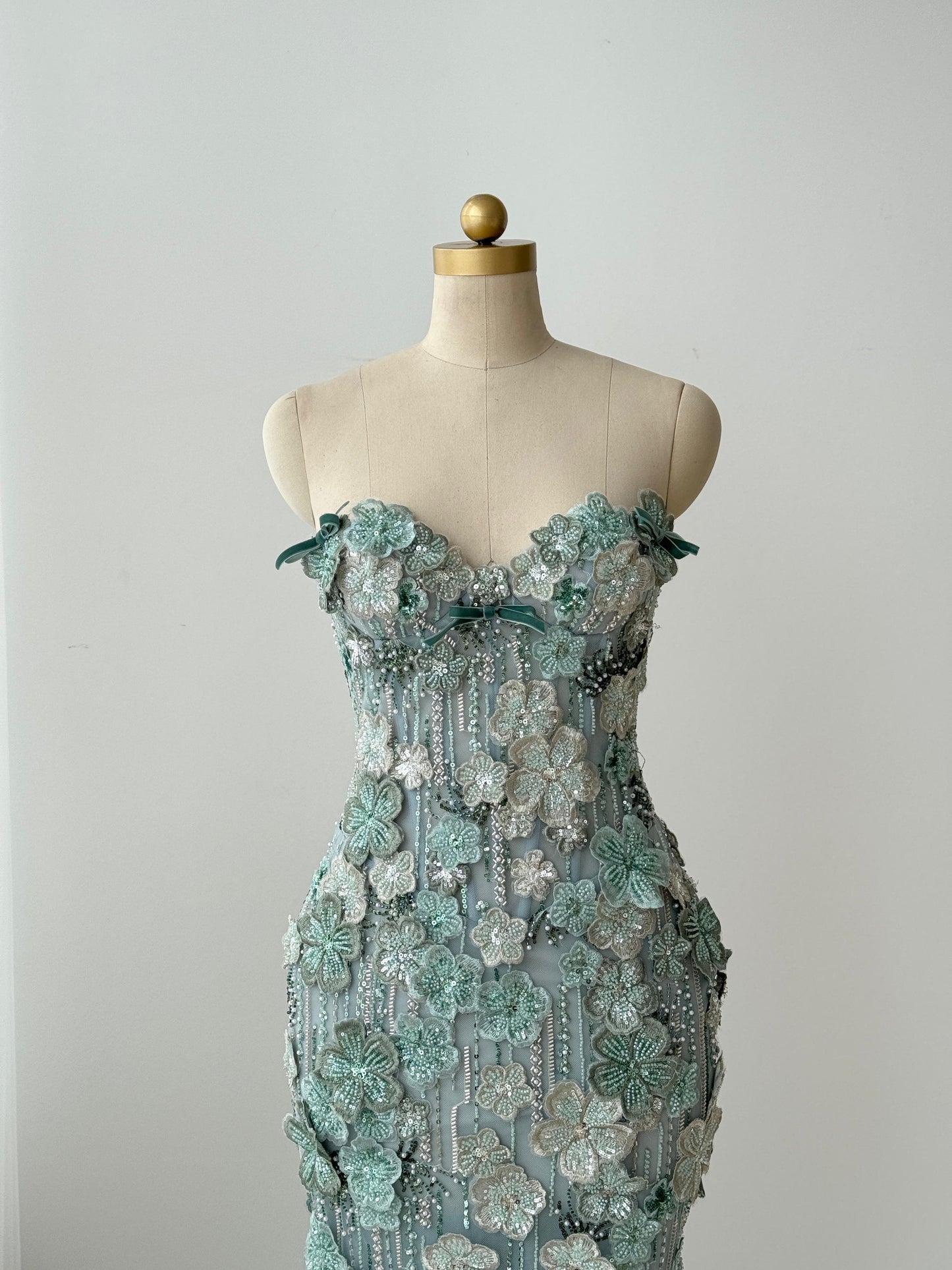 Turquoise mermaid gown with embroidered flowers and no sleeves