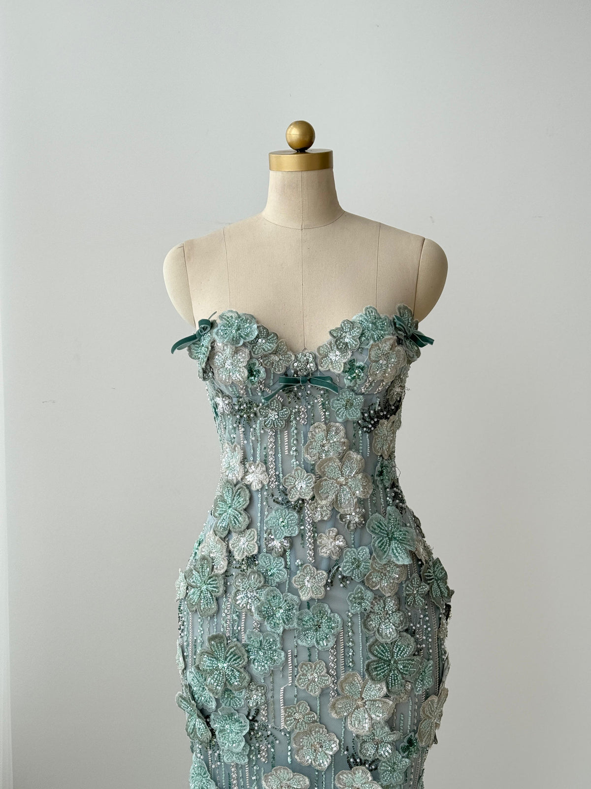 Turquoise mermaid gown with embroidered flowers and no sleeves