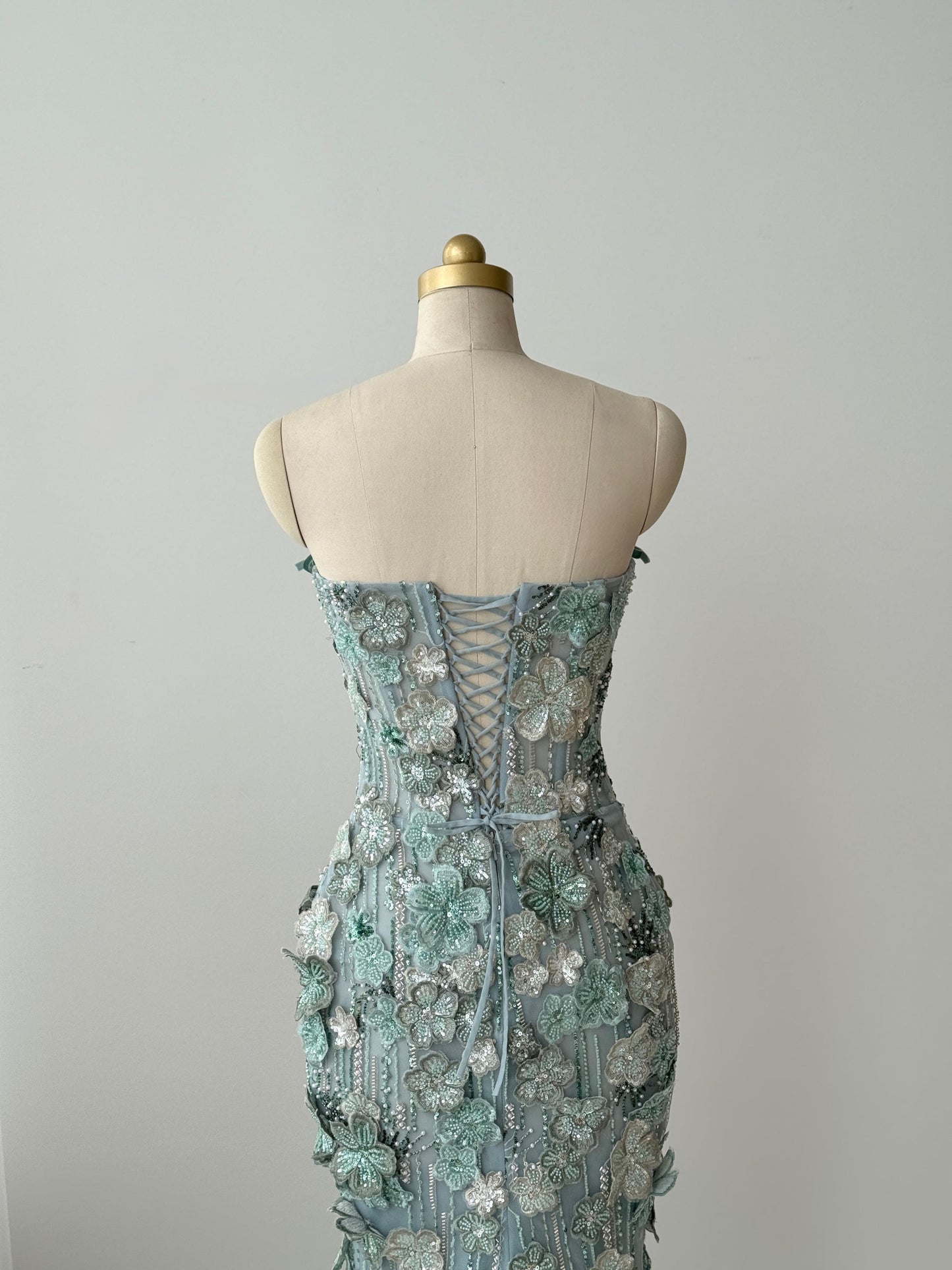 Turquoise mermaid gown with embroidered flowers and no sleeves