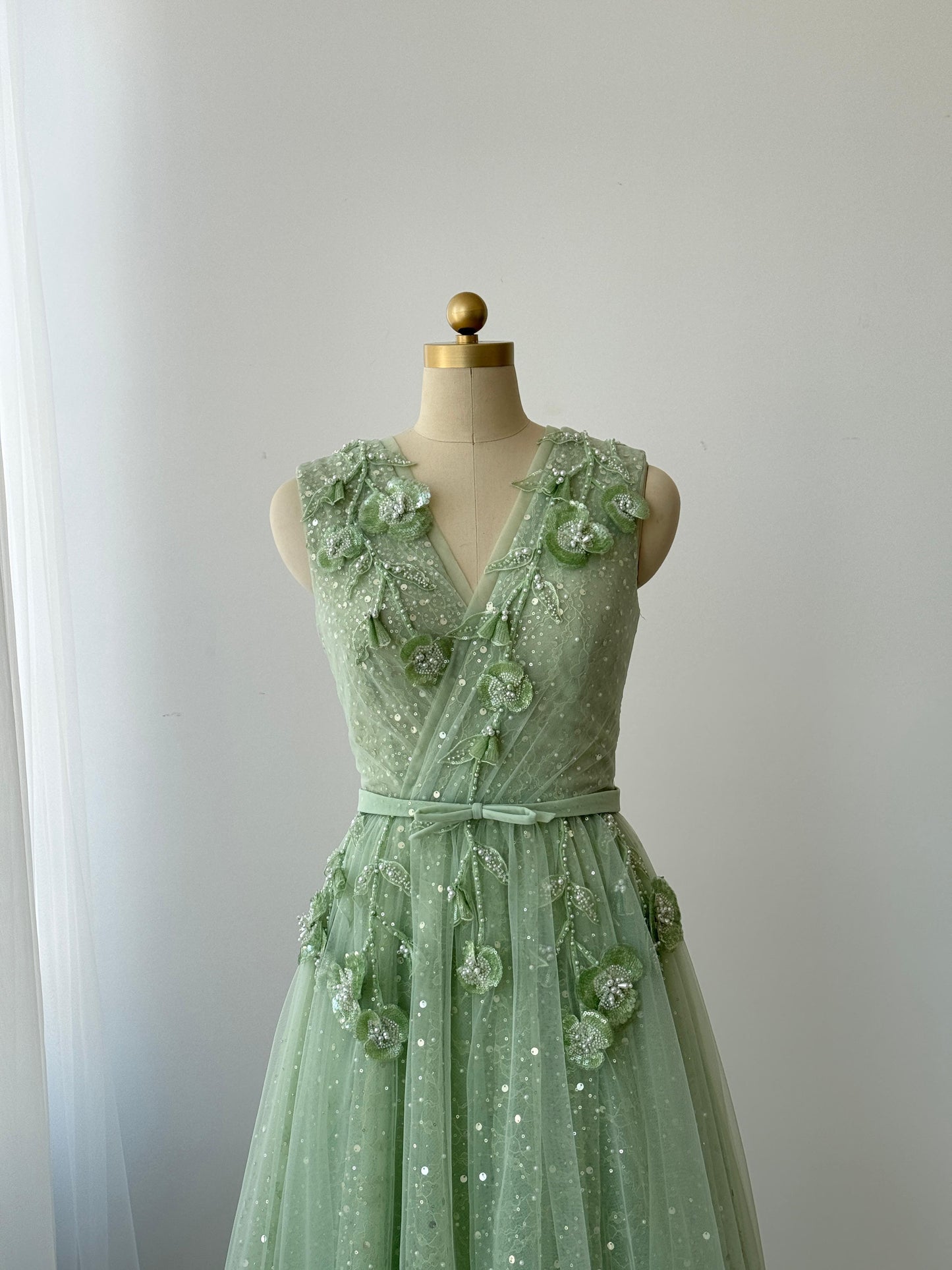 Green A-Line gown with v-neck, embroidery and no sleeves