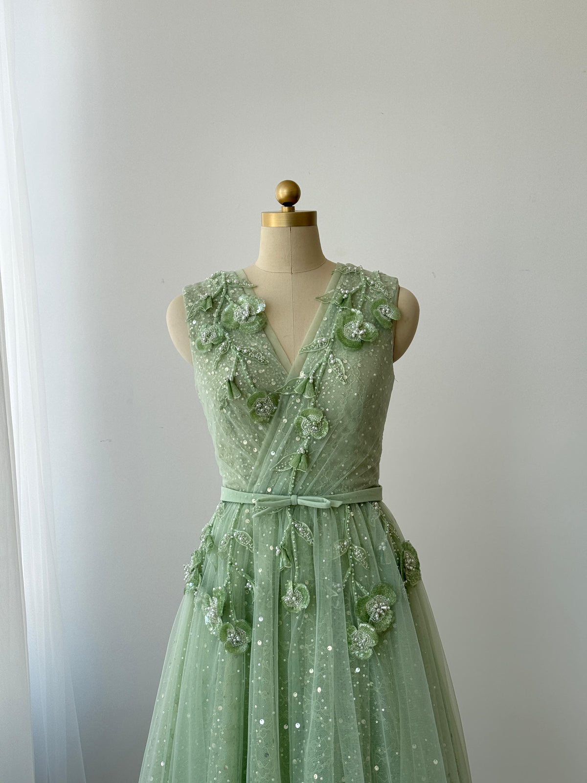 Green A-Line gown with v-neck, embroidery and no sleeves