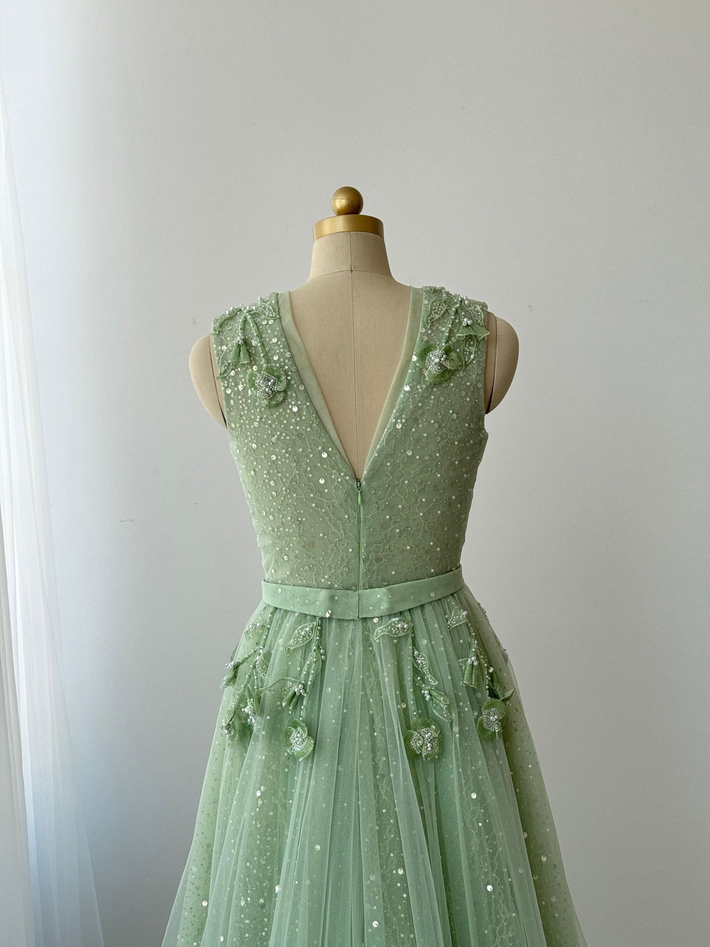 Green A-Line gown with v-neck, embroidery and no sleeves