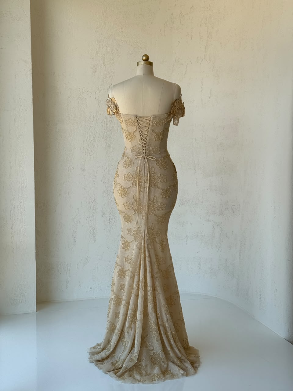 Beige mermaid gown with off the shoulder sleeves and embroidery