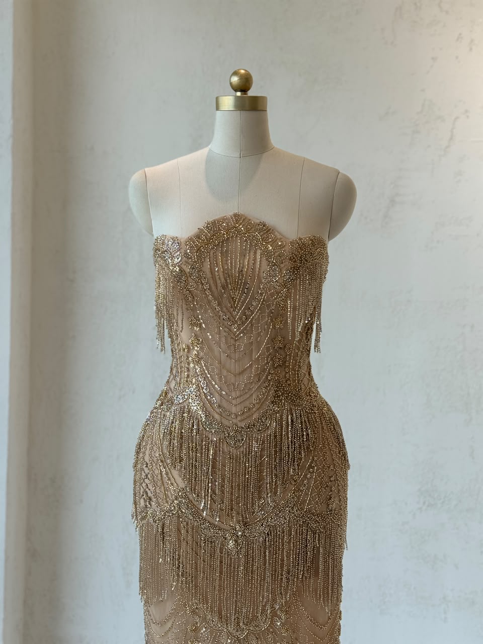 Gold mermaid gown with no sleeves and fringes