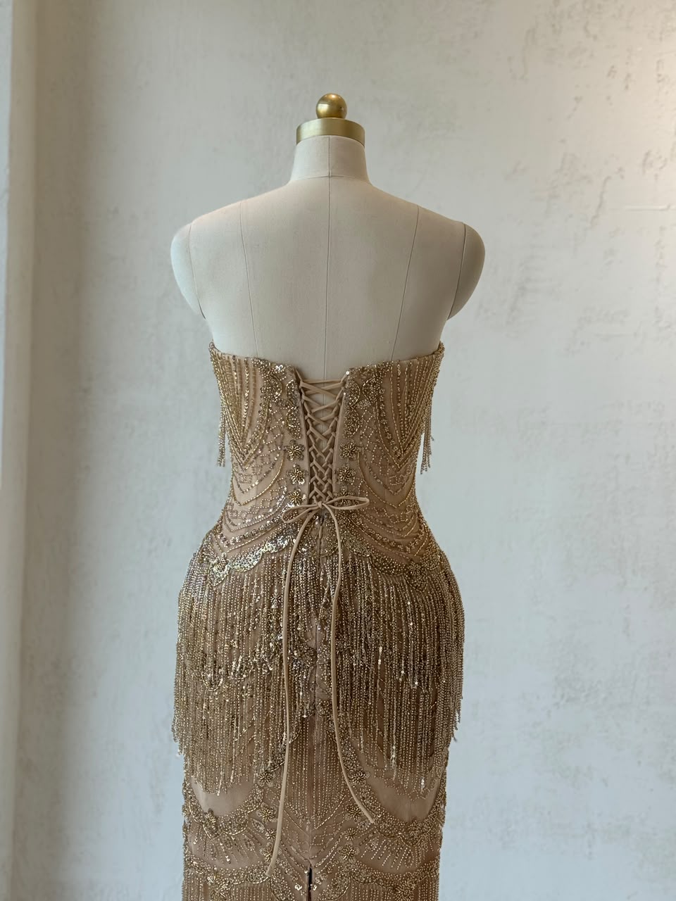 Gold mermaid gown with no sleeves and fringes