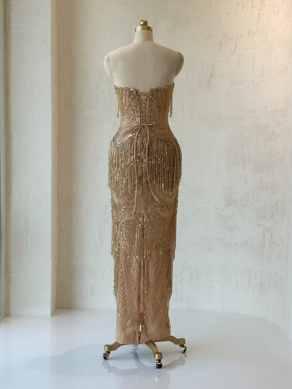 Gold mermaid gown with no sleeves and fringes