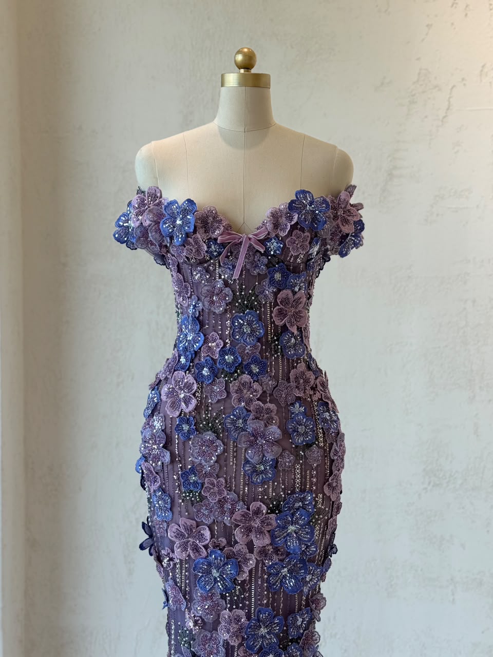 Purple mermaid gown with of the shoulder sleeves and embroidered flowers