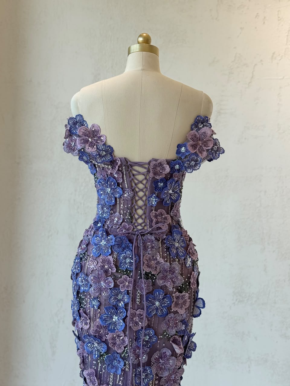 Purple mermaid gown with of the shoulder sleeves and embroidered flowers