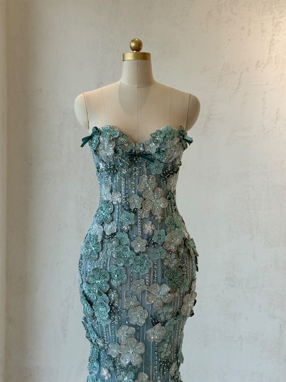 Turquoise mermaid gown with embroidered flowers and no sleeves