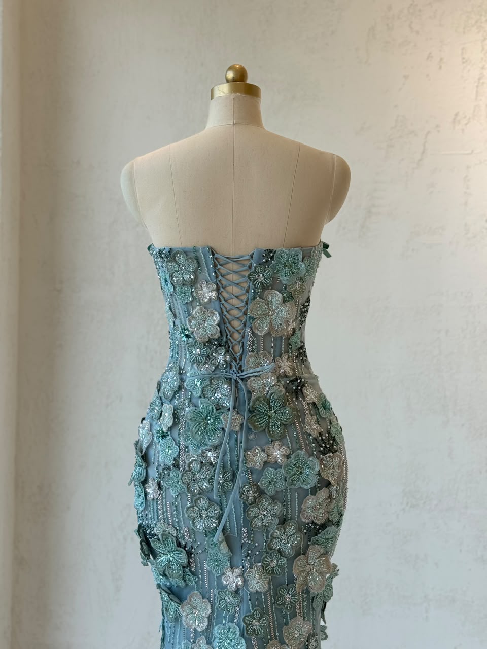 Turquoise mermaid gown with embroidered flowers and no sleeves