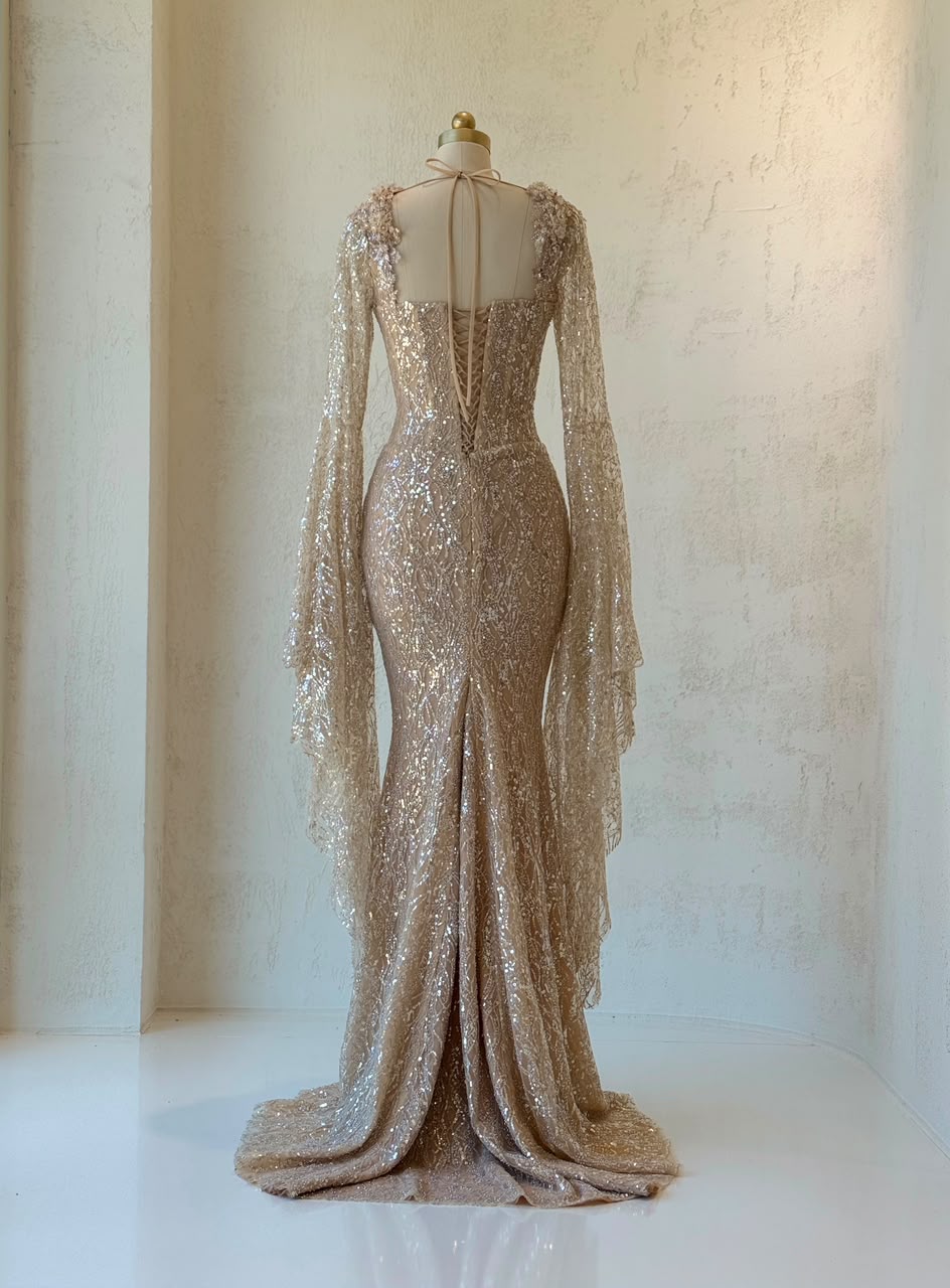 Beige mermaid gown with long flutter sleeves, embroidered bow, sequins and embroidery