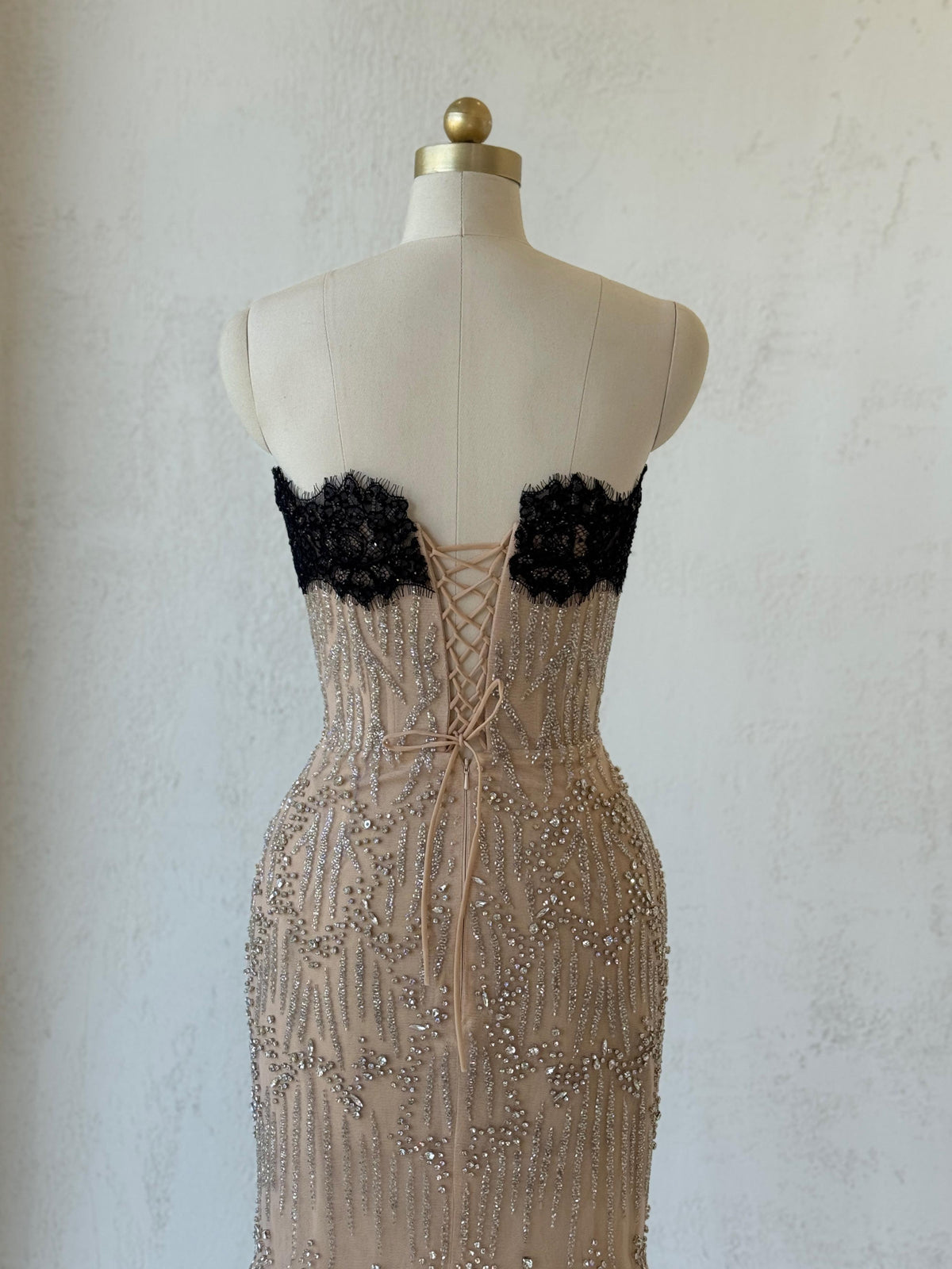 Beige mermaid gown with embroidered lace, beading and no sleeves