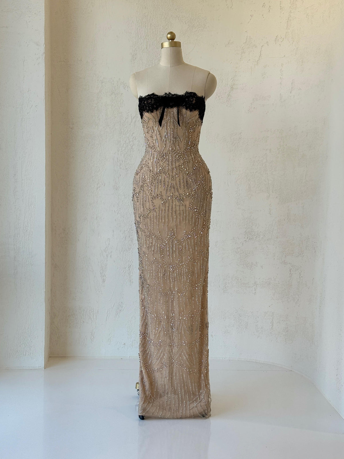 Beige mermaid gown with embroidered lace, beading and no sleeves