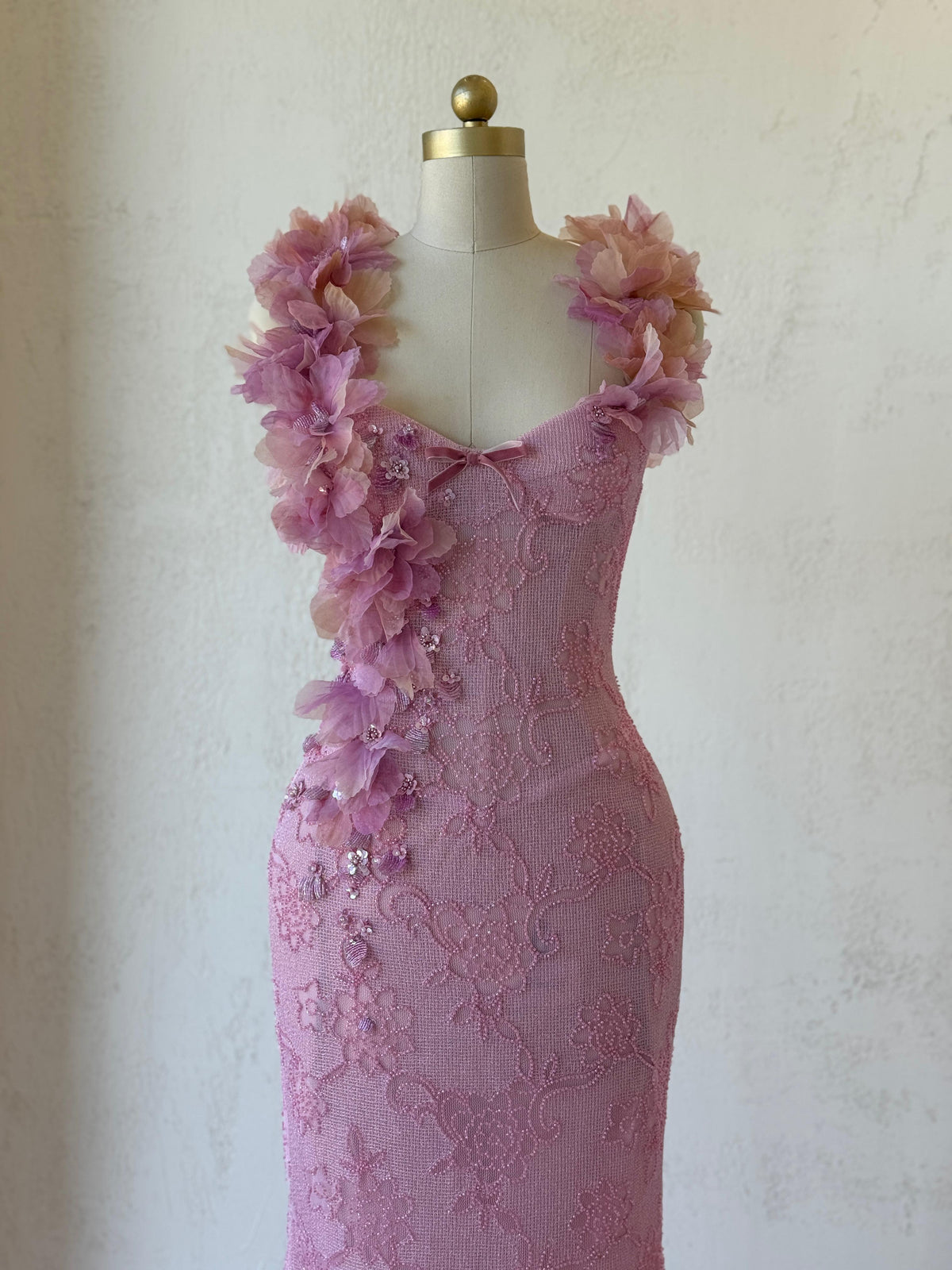 Pink mermaid gown with straps, floral embroidery and bow