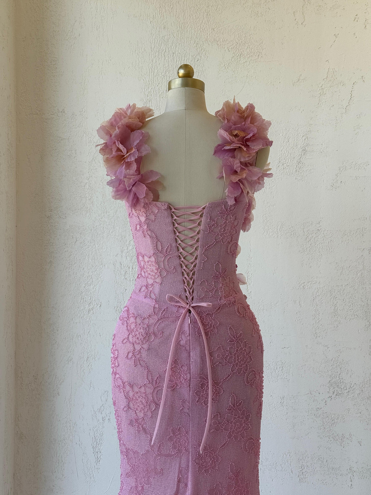 Pink mermaid gown with straps, floral embroidery and bow