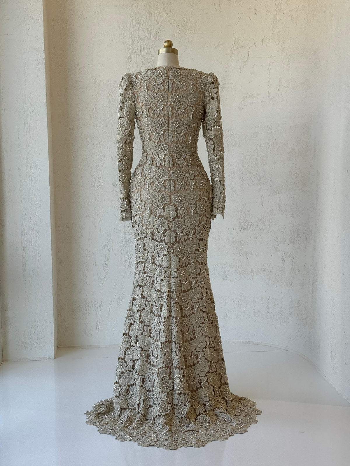 Beige mermaid gown with lace, beading, embroidery, bow, v-neck and long sleeves