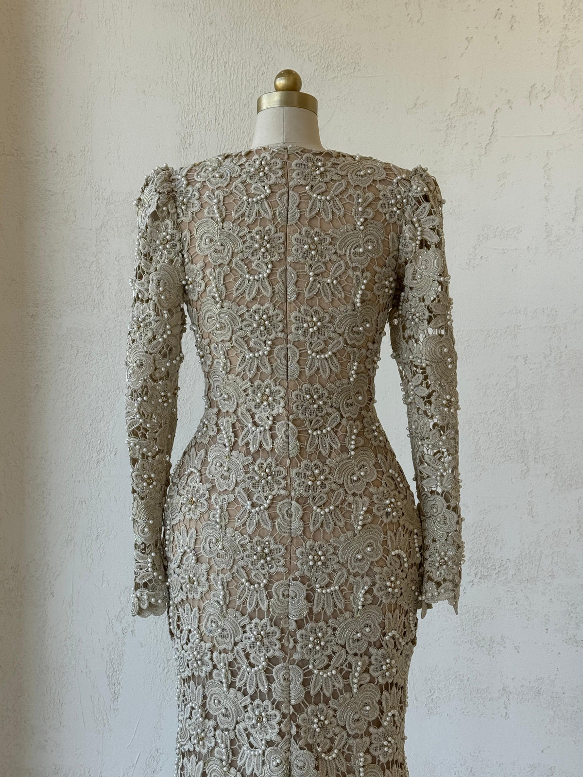 Beige mermaid gown with lace, embroidery, bow, v-neck and long sleeves