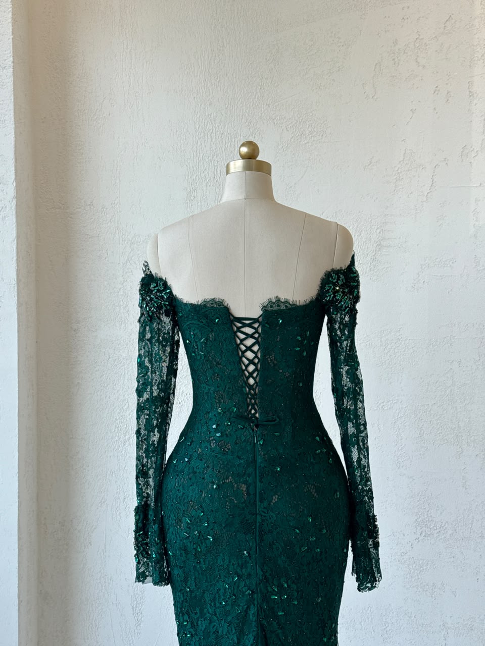 Green mermaid gown with long off the shoulder sleeves, embroidery and lace