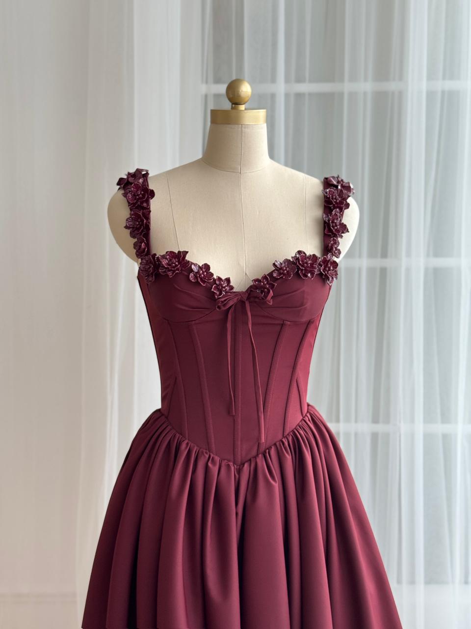 Burgundy midi dress with detailed bow and embroidered straps