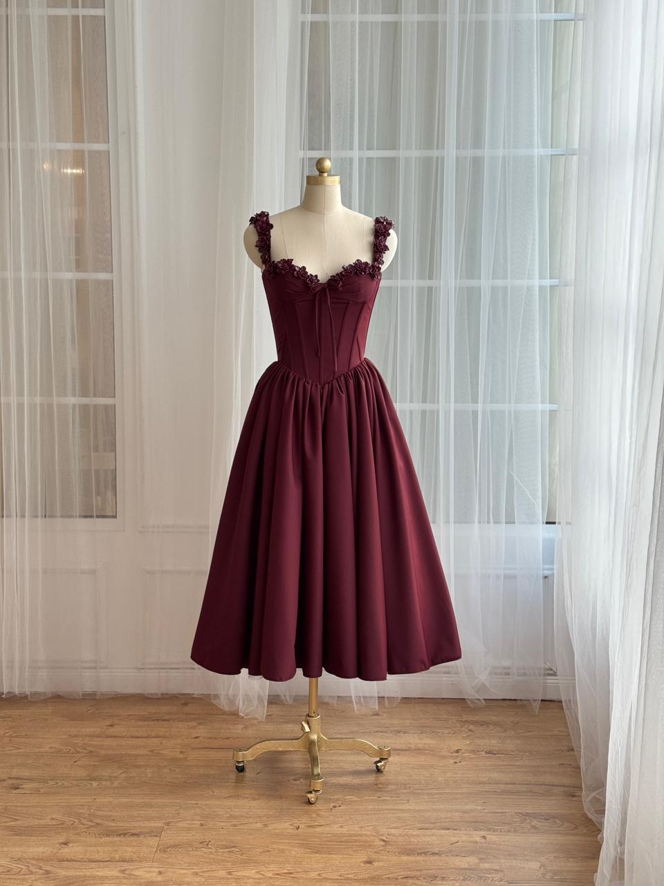 Burgundy midi dress with detailed bow and embroidered straps