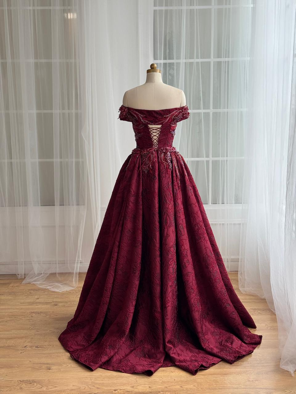 Red A-Line gown with overskirt, off the shoulder sleeves and embroidery