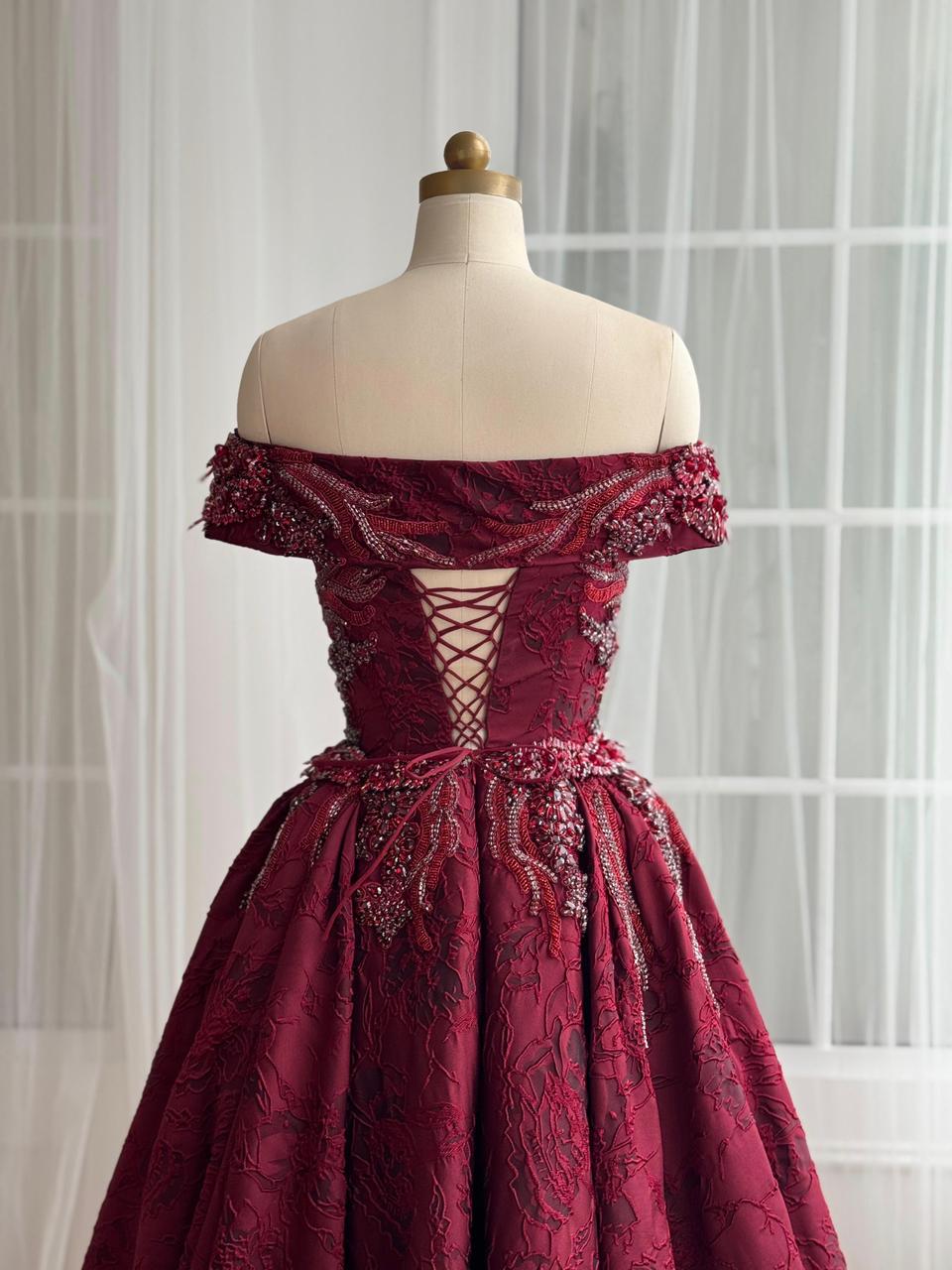Red A-Line gown with overskirt, off the shoulder sleeves and embroidery