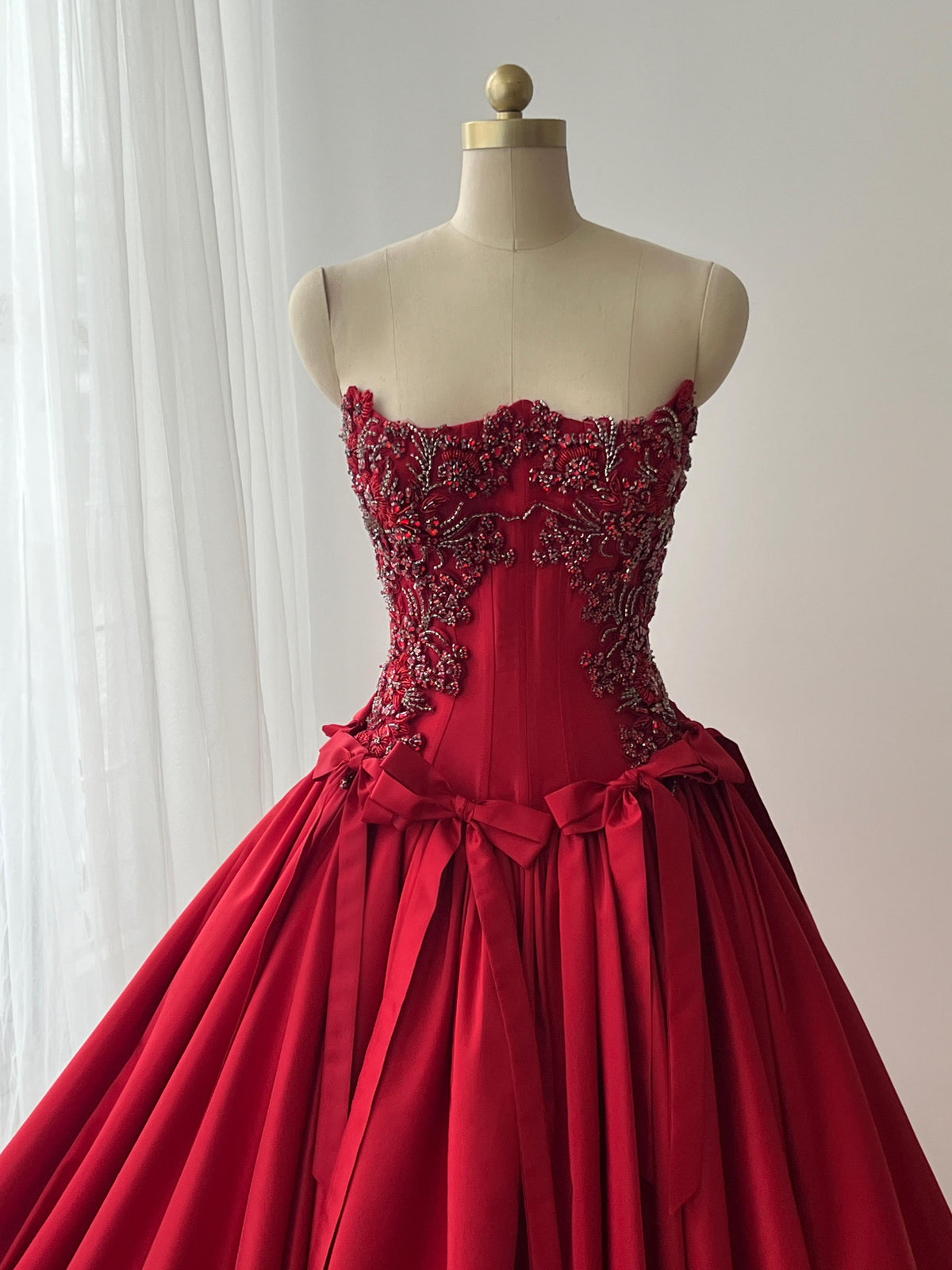 Red A-Line dress with embroidery, bows and no sleeves