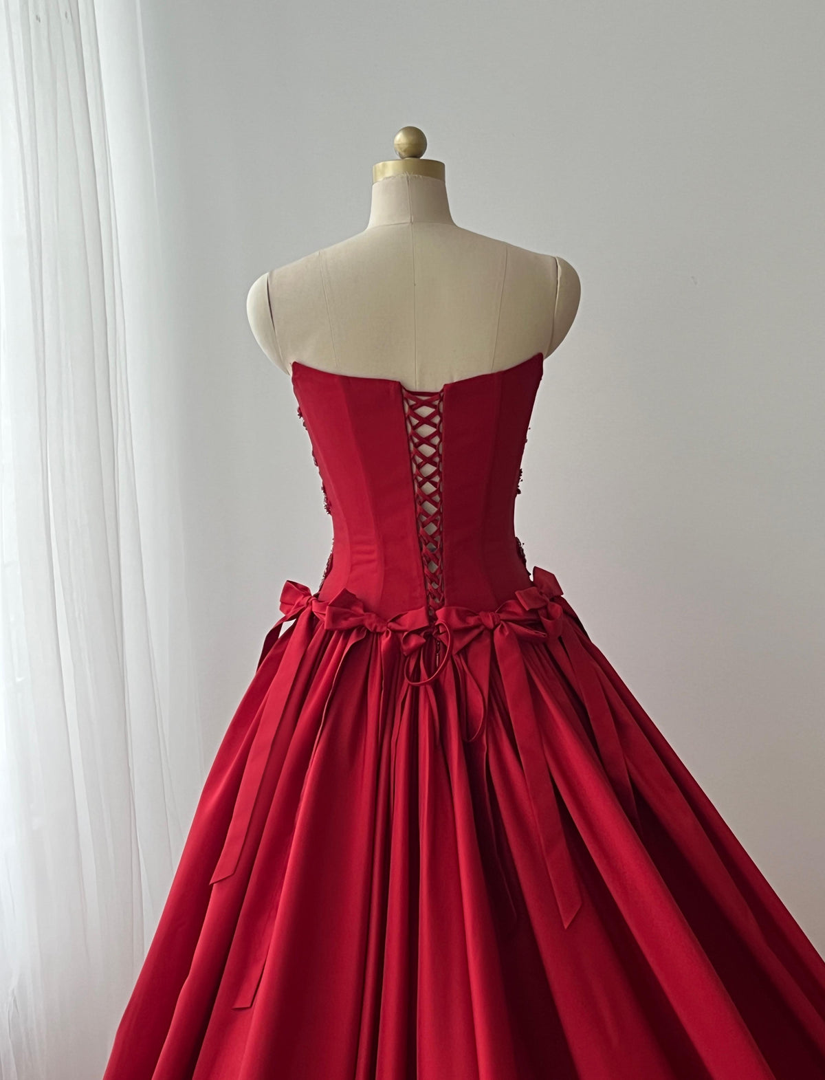 Red A-Line dress with embroidery, bows and no sleeves