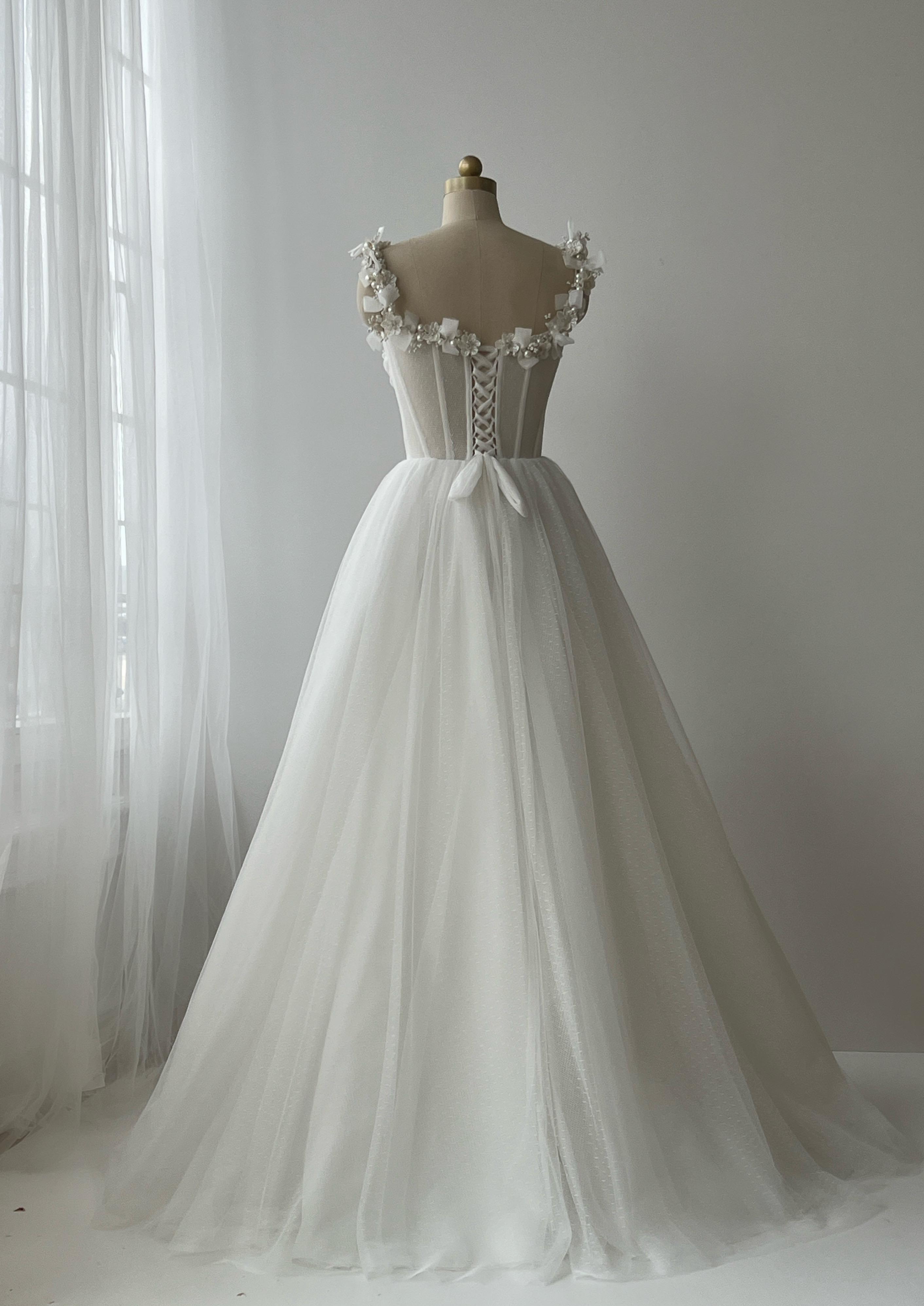 White bridal A-Line gown with straps, embroidery and pearls