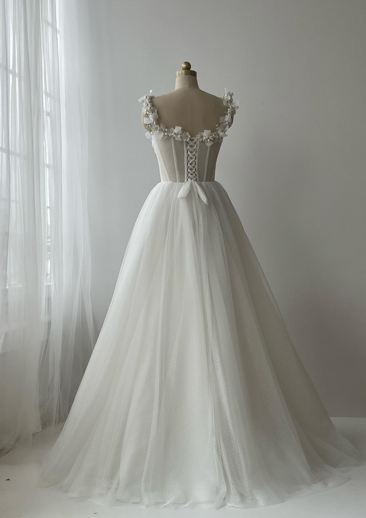White bridal A-Line gown with straps, embroidery and pearls