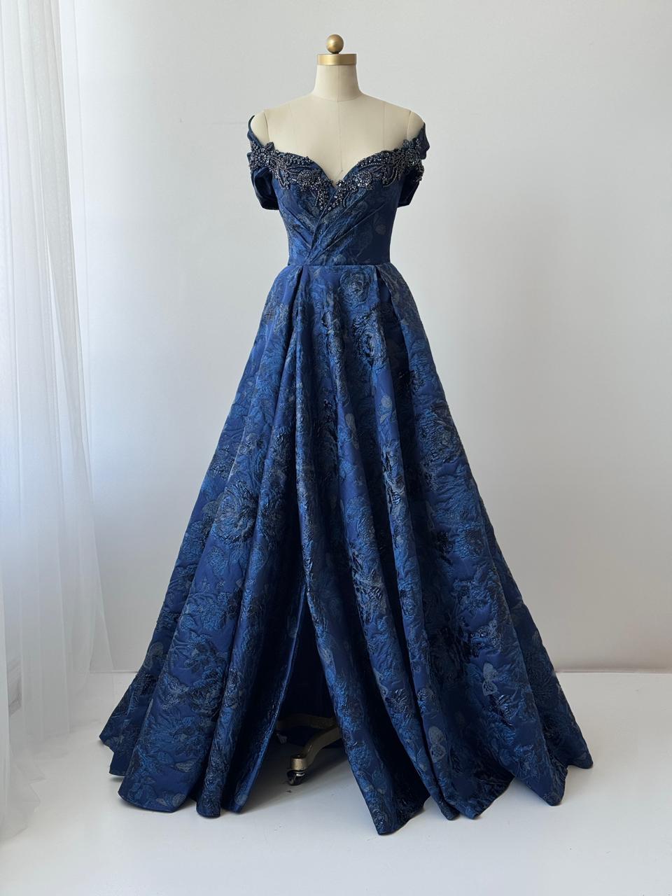 Blue A-Line gown with off the shoulder sleeves, embroidery and brocade fabric