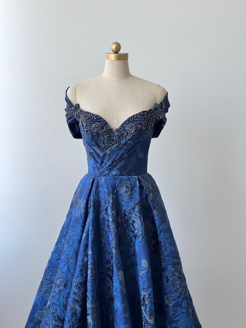 Blue A-Line gown with off the shoulder sleeves, embroidery and brocade fabric