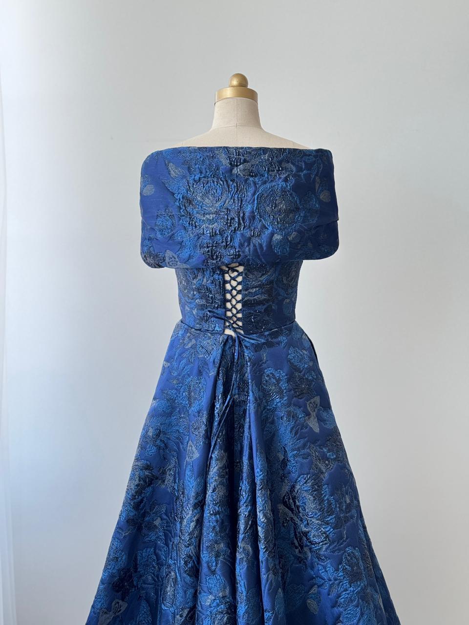 Blue A-Line gown with off the shoulder sleeves, embroidery and brocade fabric