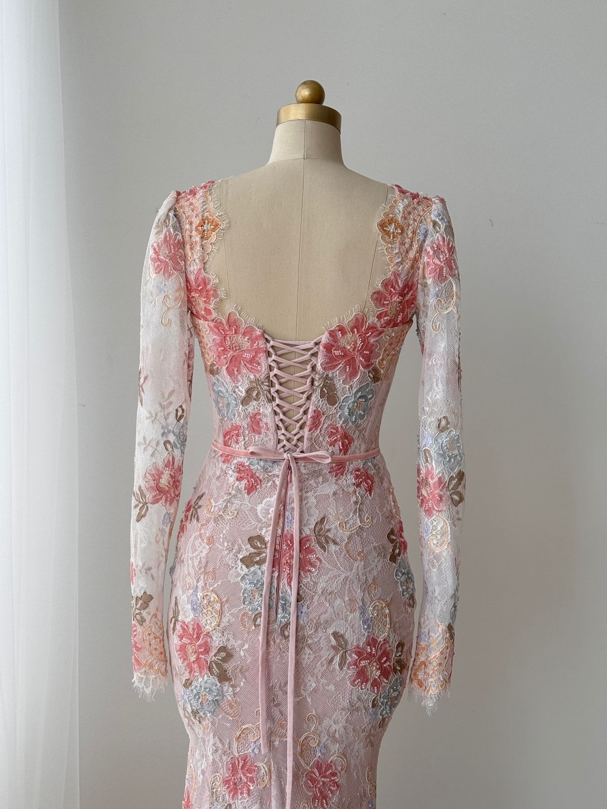 Pink mermaid gown with long sleeves, floral lace and embroidery