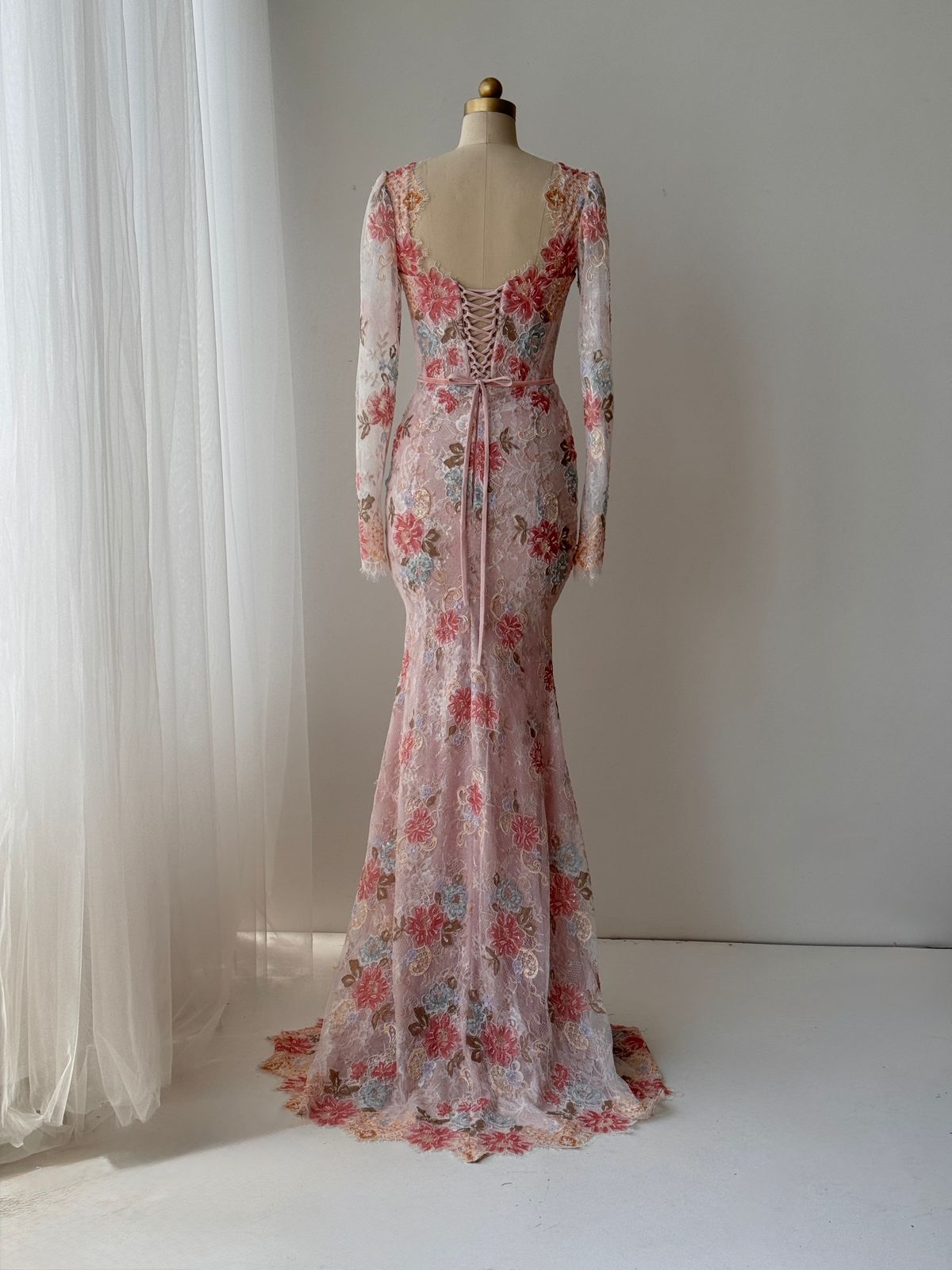 Pink mermaid gown with long sleeves, floral lace and embroidery