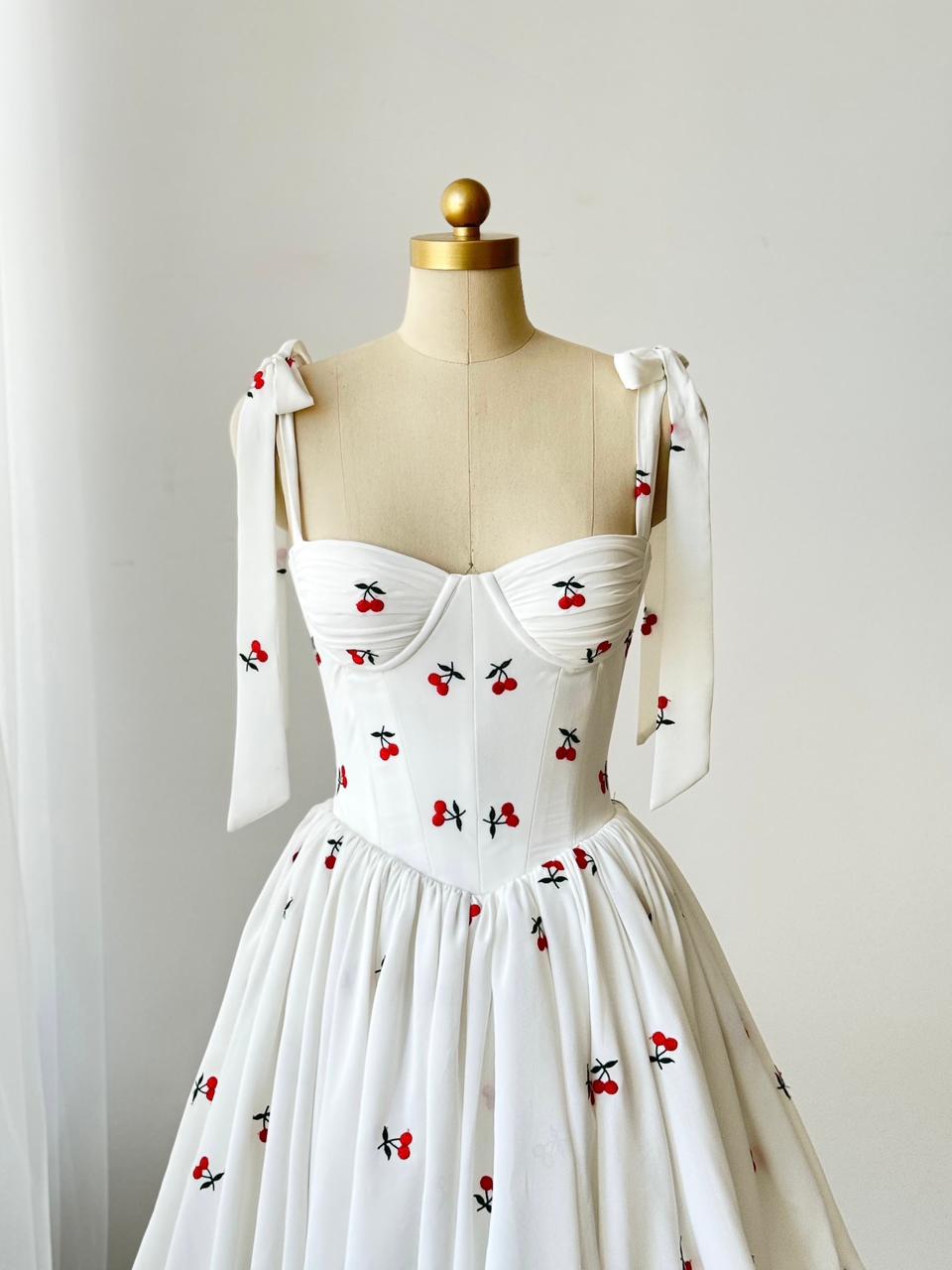 White mini dress with bow straps and cherries