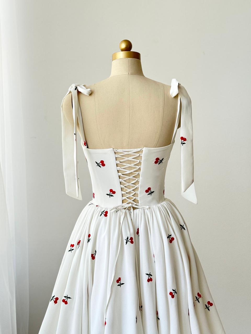 White mini dress with bow straps and cherries