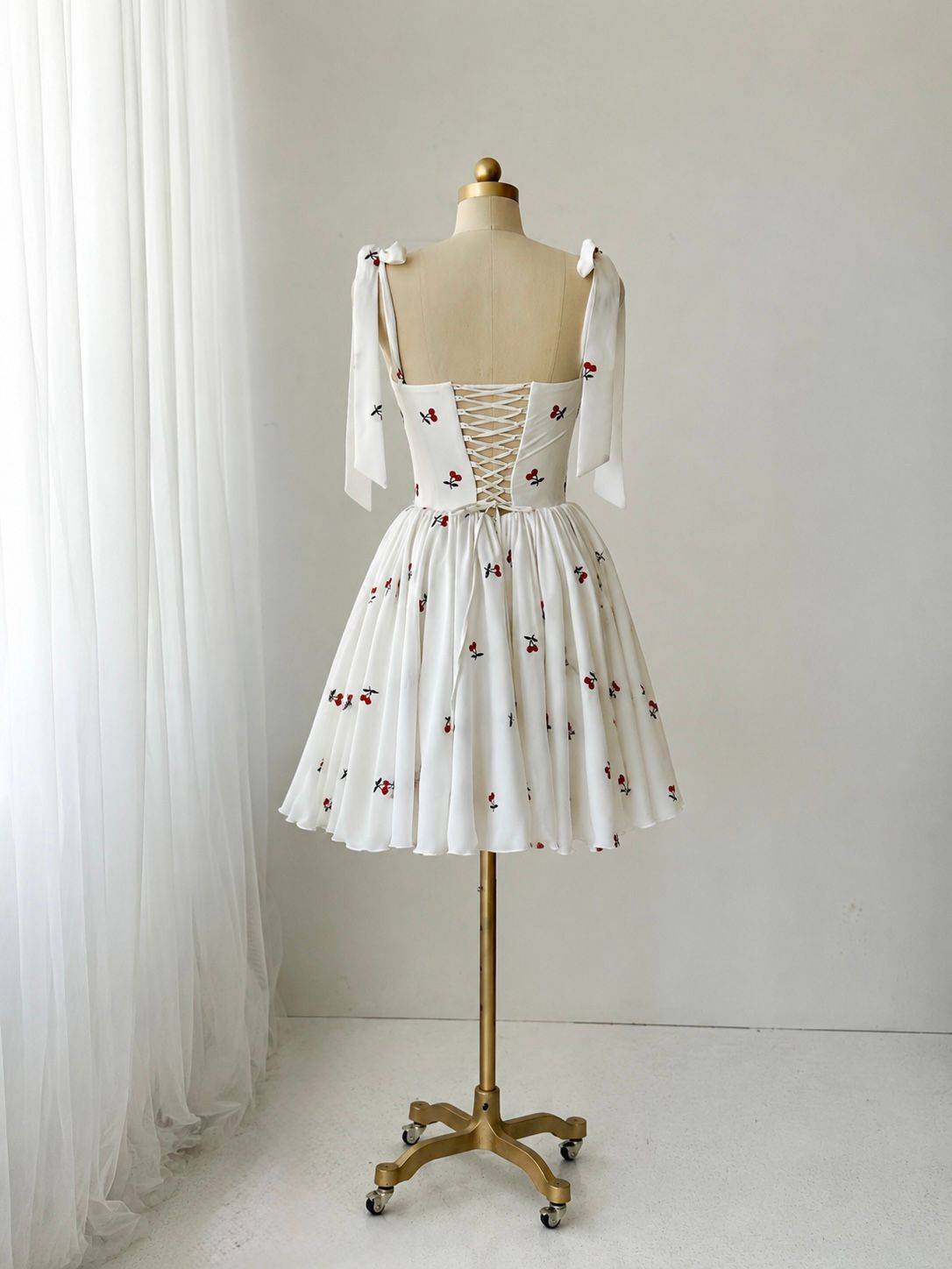 White mini dress with bow straps and cherries