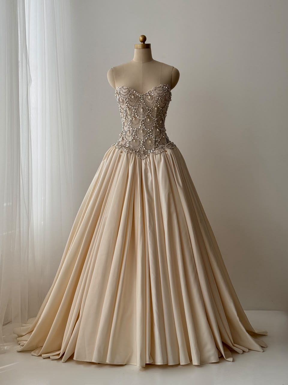 Beige A-Line bridal gown, with beading work, embroidery and no sleeves