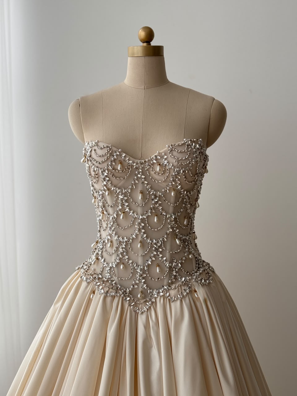 Beige A-Line bridal gown, with beading work, embroidery and no sleeves
