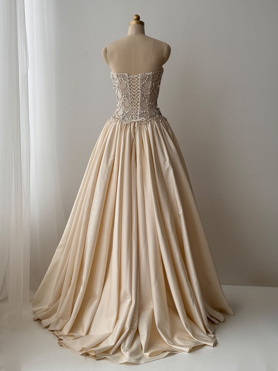Beige A-Line bridal gown, with beading work, embroidery and no sleeves