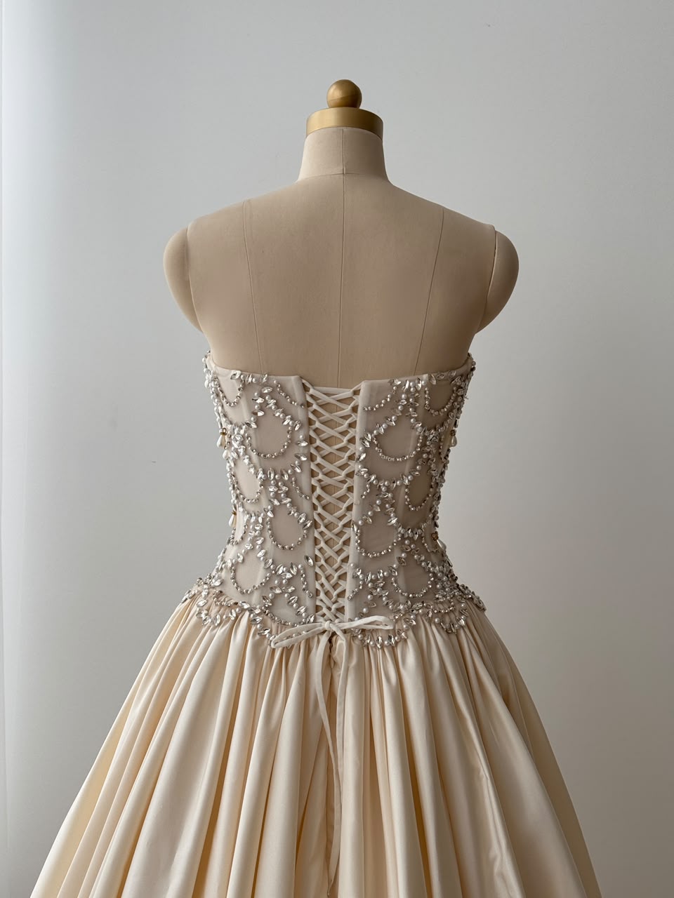 Beige A-Line bridal gown, with beading work, embroidery and no sleeves