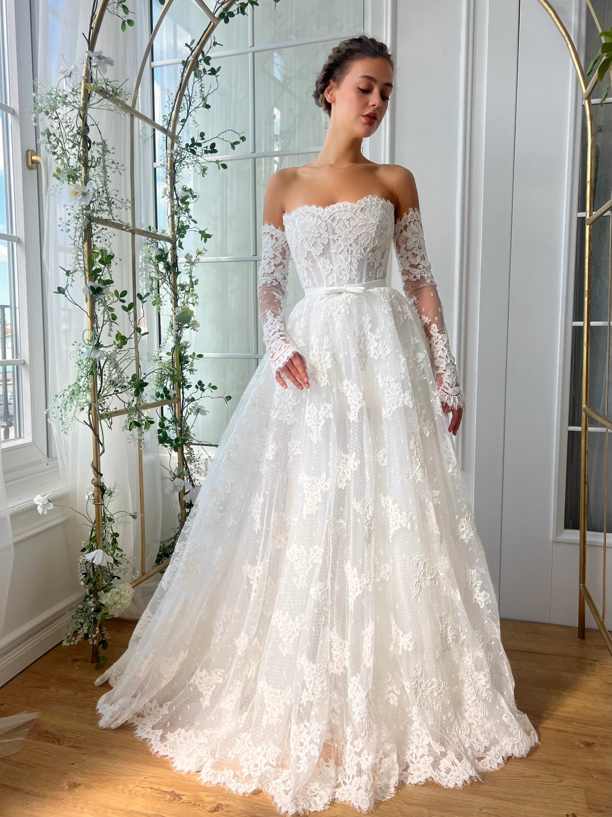 White bridal A-Line gown with long off the shoulders sleeves and embroidery
